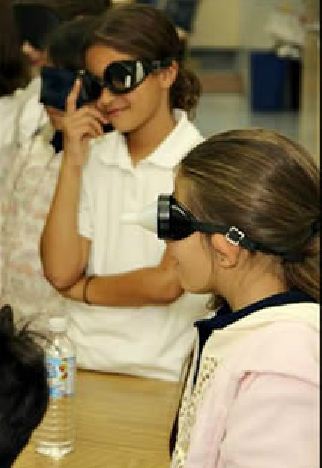 Elementary girls wearing special glasses to experience being blind